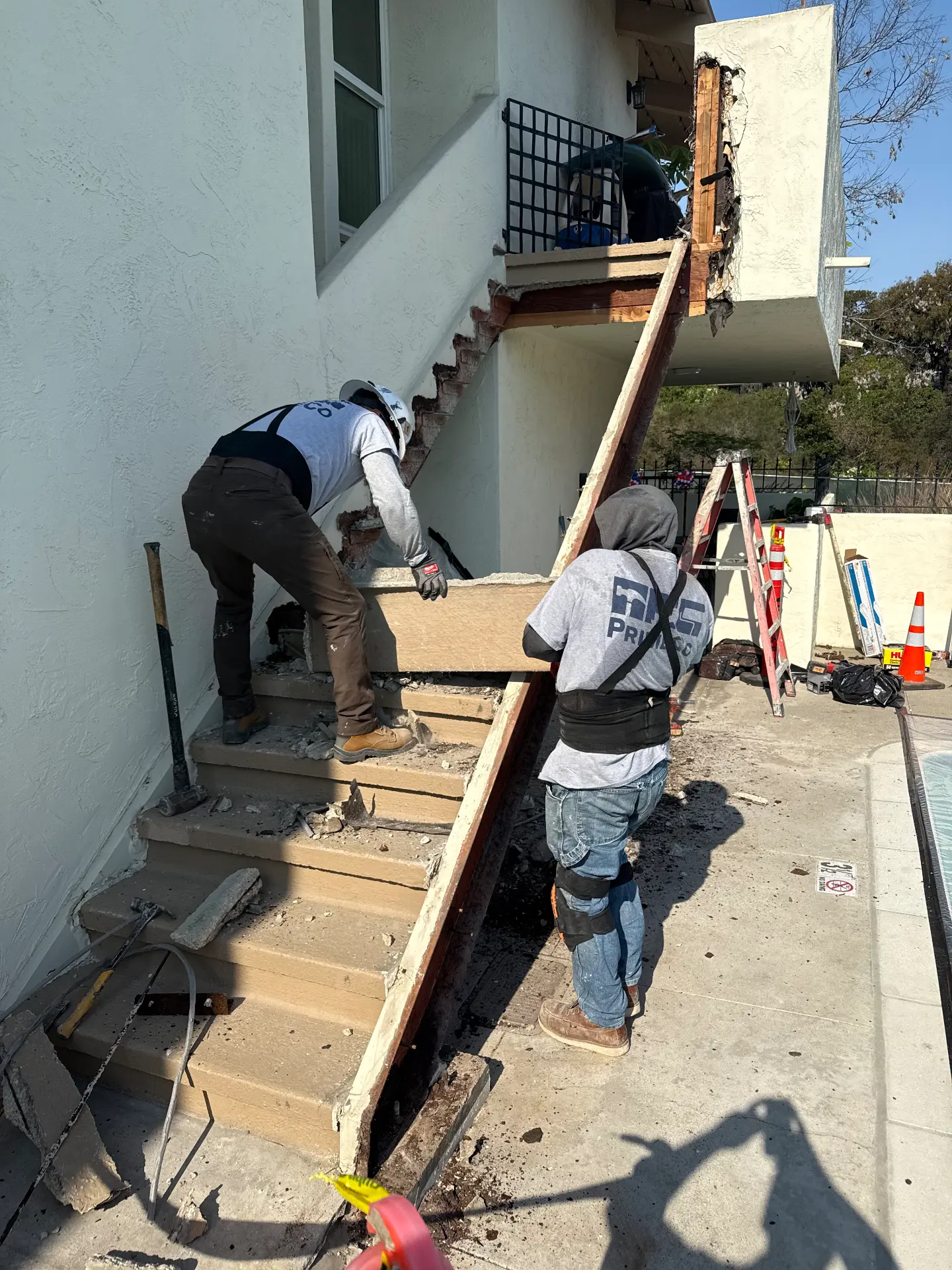 Crews removing failed stair treads and framing